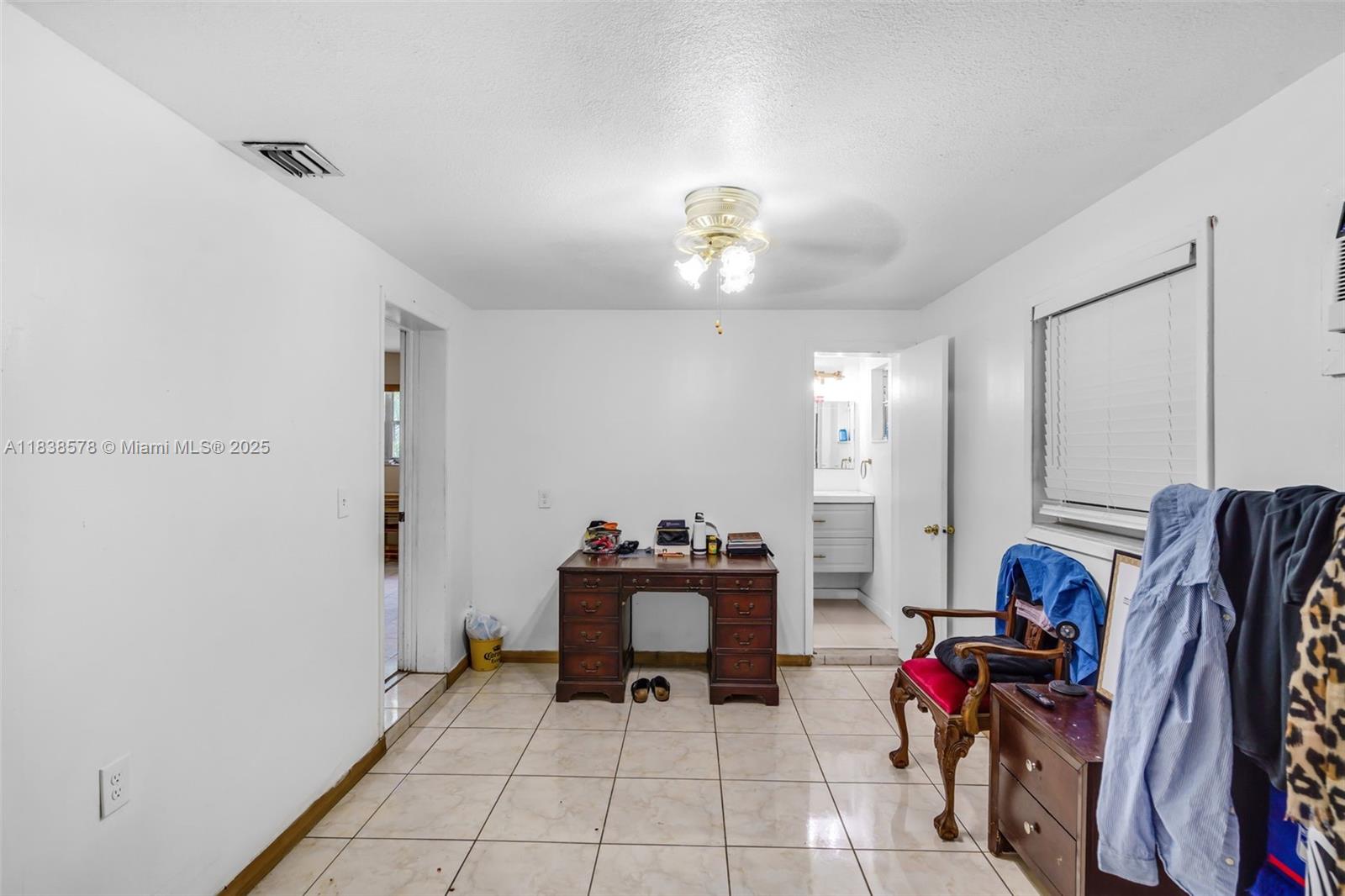 2761 Southwest 33rd Court Miami, FL 33133 - Photo 14 of 46 a view of a workspace with furniture and gym equipment