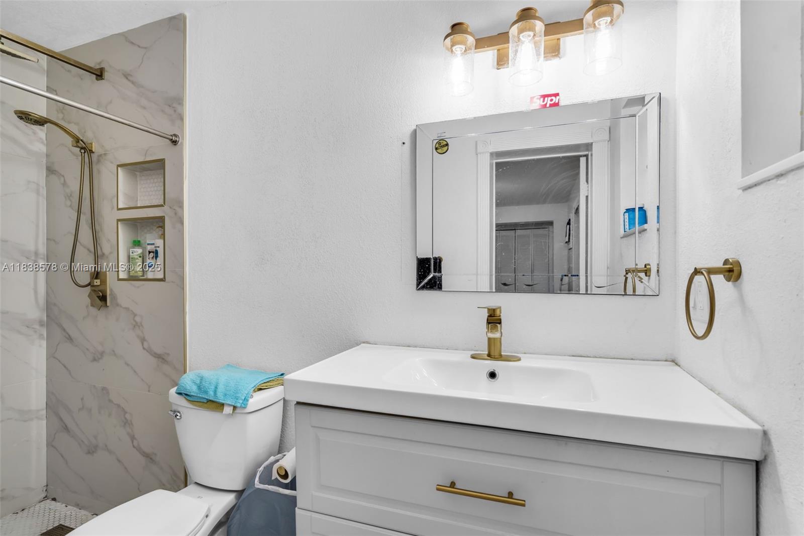 2761 Southwest 33rd Court Miami, FL 33133 - Photo 15 of 46 a bathroom with a sink toilet a mirror and shower