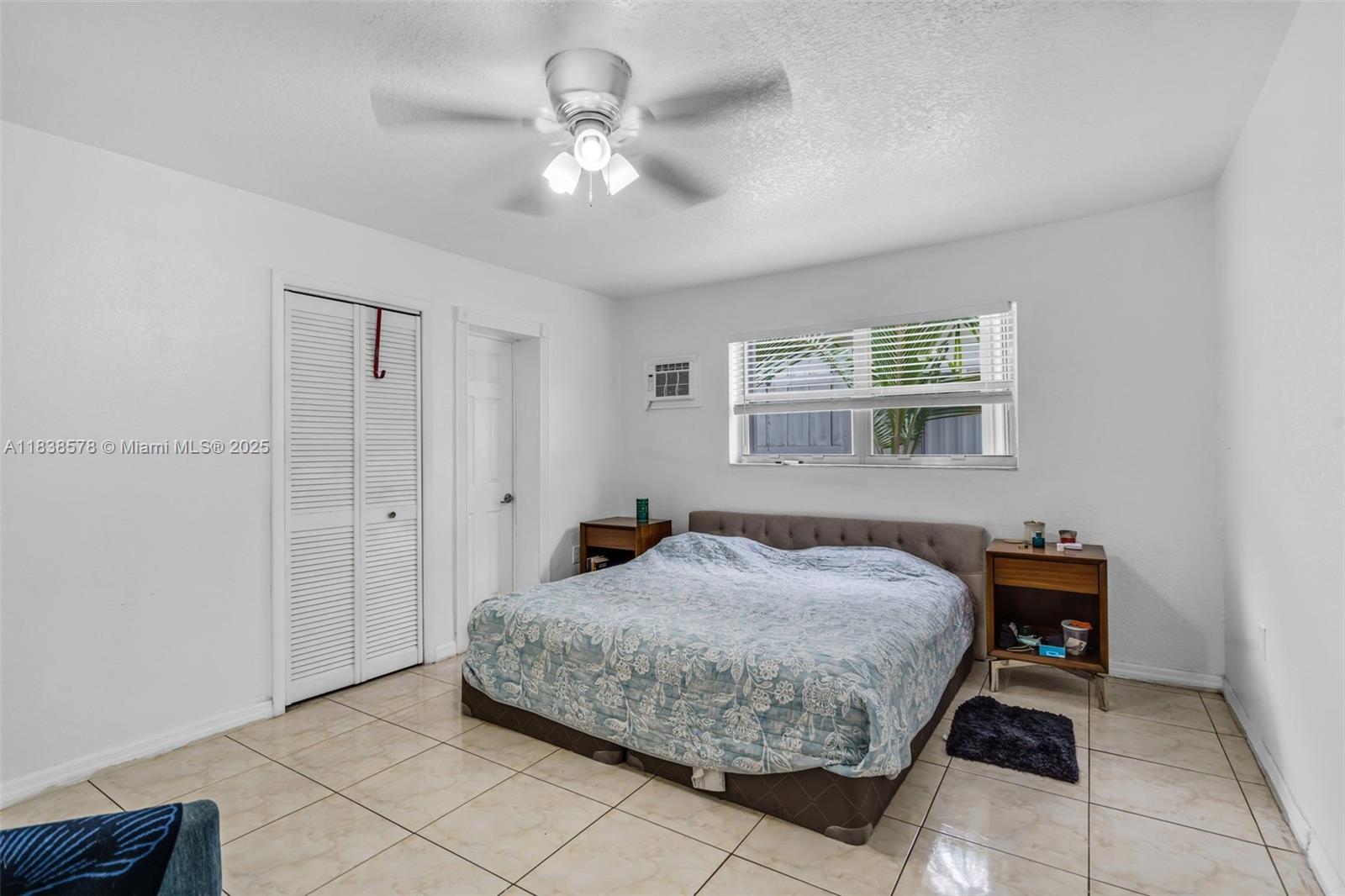 2761 Southwest 33rd Court Miami, FL 33133 - Photo 17 of 46 a bedroom with a bed and a chandelier