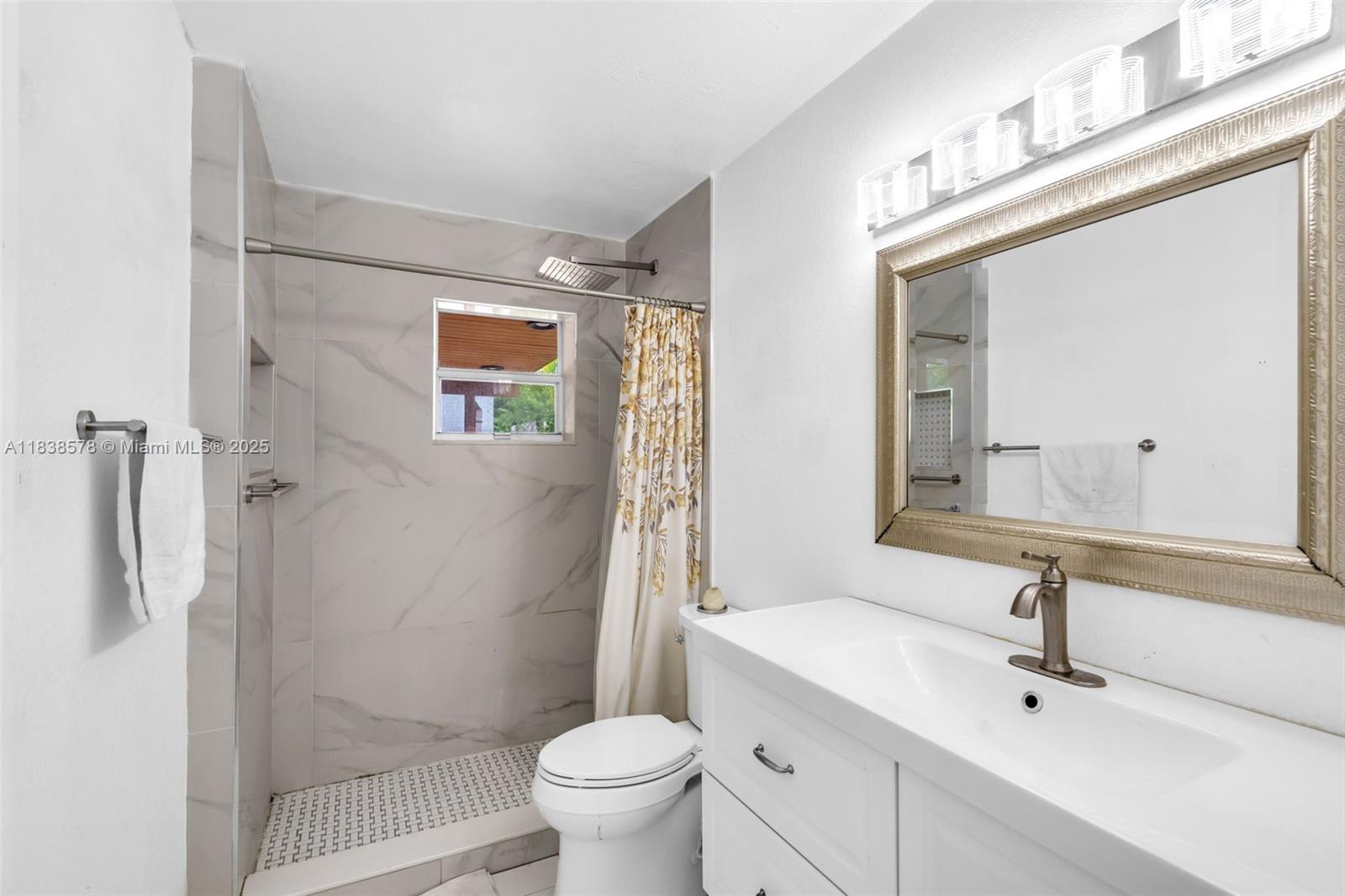 2761 Southwest 33rd Court Miami, FL 33133 - Photo 19 of 46 a bathroom with a sink a toilet and shower