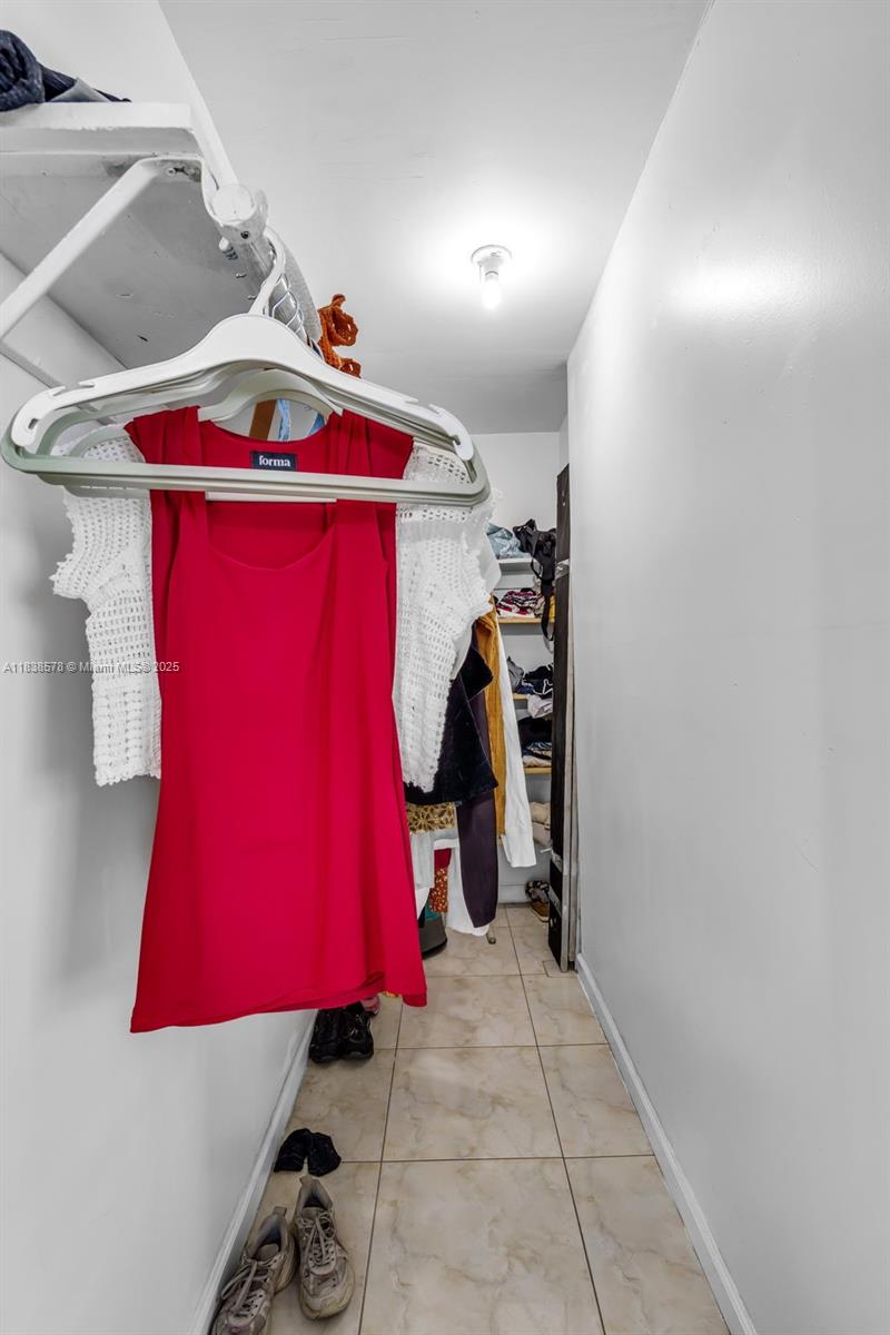 2761 Southwest 33rd Court Miami, FL 33133 - Photo 20 of 46 a view of walk in closet with clothes and shoes