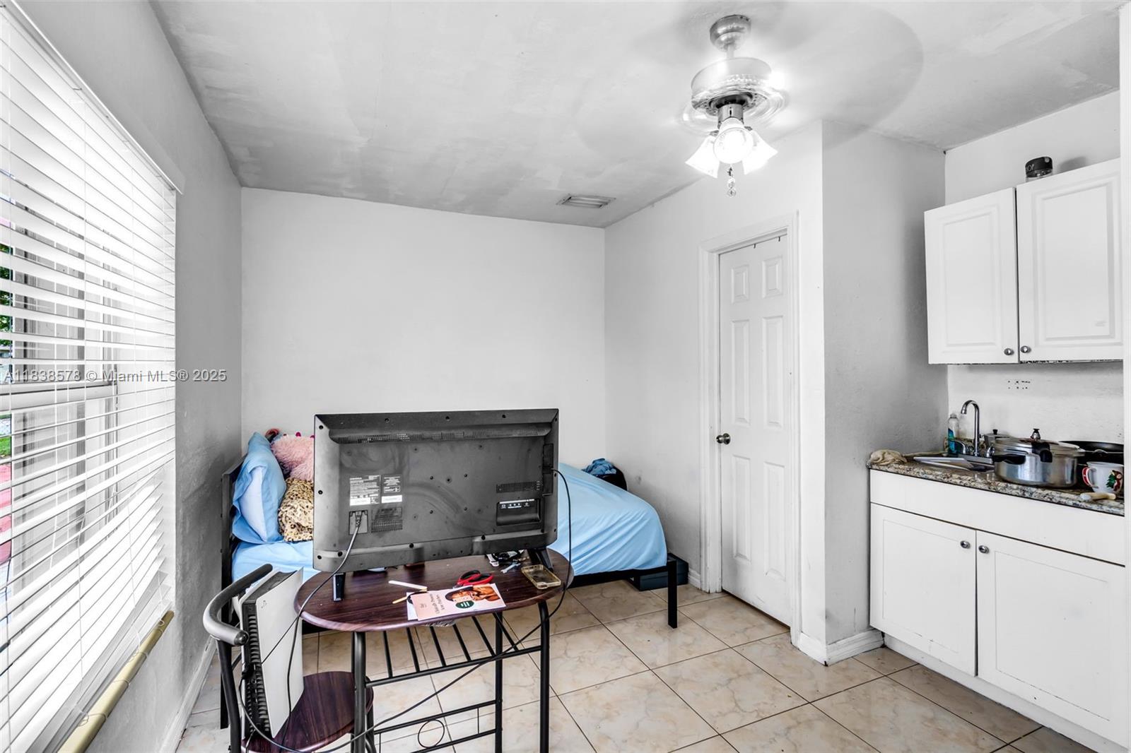 2761 Southwest 33rd Court Miami, FL 33133 - Photo 21 of 46 a kitchen with stainless steel appliances a stove a chimney a sink and cabinets