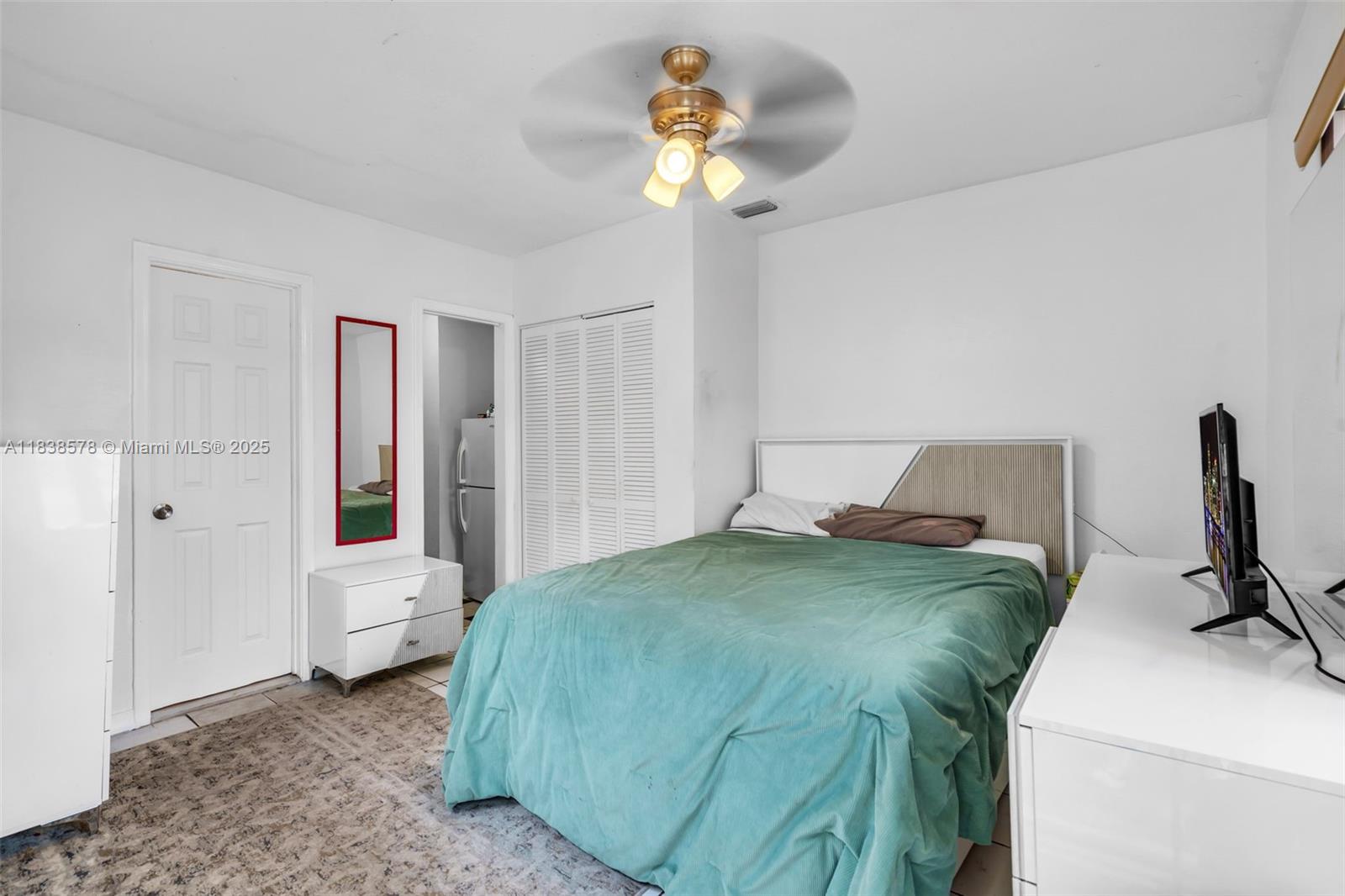 2761 Southwest 33rd Court Miami, FL 33133 - Photo 23 of 46 a bedroom with a bed and a chandelier