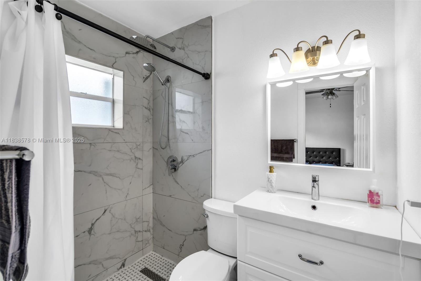 2761 Southwest 33rd Court Miami, FL 33133 - Photo 28 of 46 a bathroom with a sink mirror and toilet