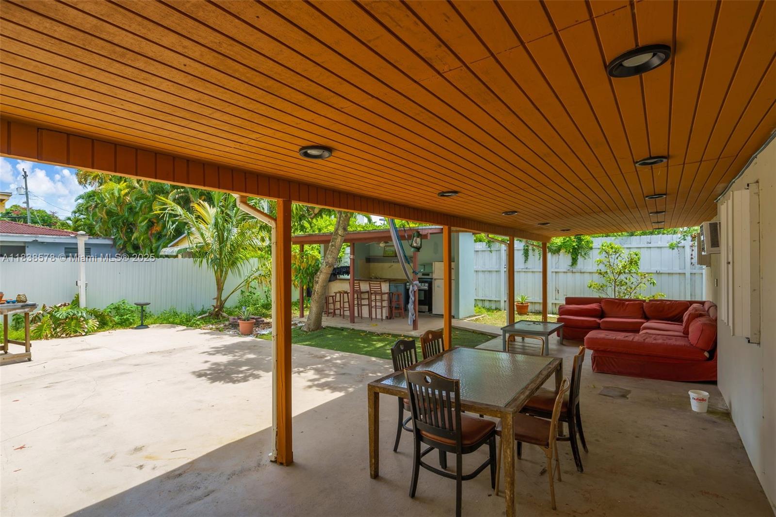 2761 Southwest 33rd Court Miami, FL 33133 - Photo 31 of 46 a view of a patio with a table chairs and a backyard
