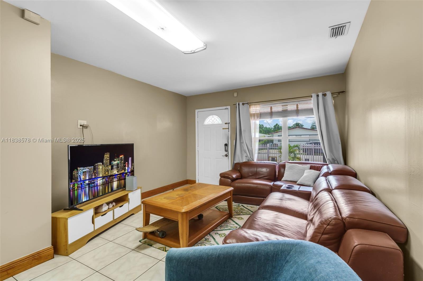 2761 Southwest 33rd Court Miami, FL 33133 - Photo 5 of 46 a living room with furniture and a flat screen tv