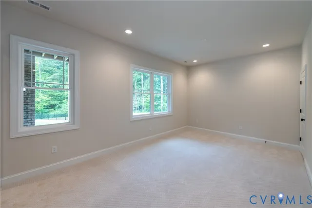 a view of a hallway with wooden floor and entryway