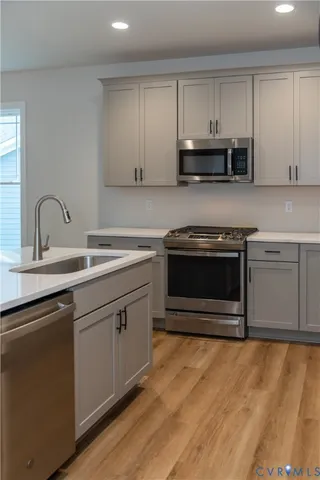 a kitchen with white cabinets and appliances