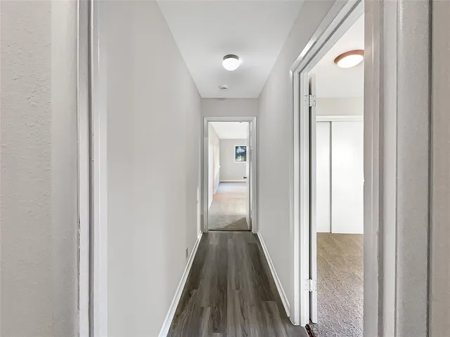 a view of a hallway with wooden floor