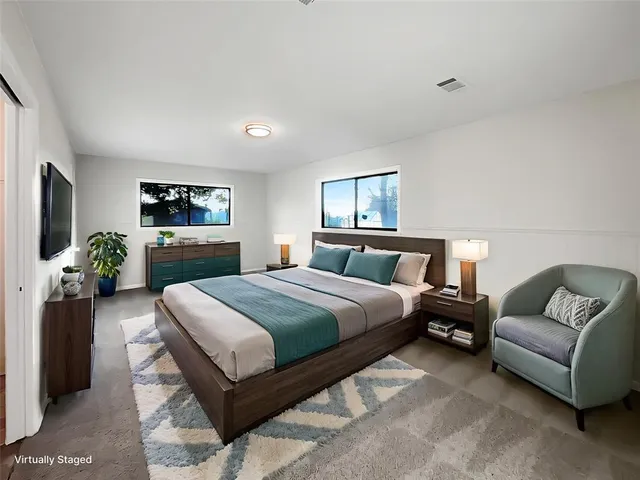 a bedroom with a bed and a couch