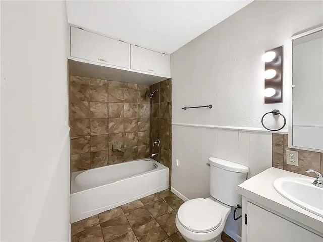 a bathroom with a toilet a sink and a bathtub