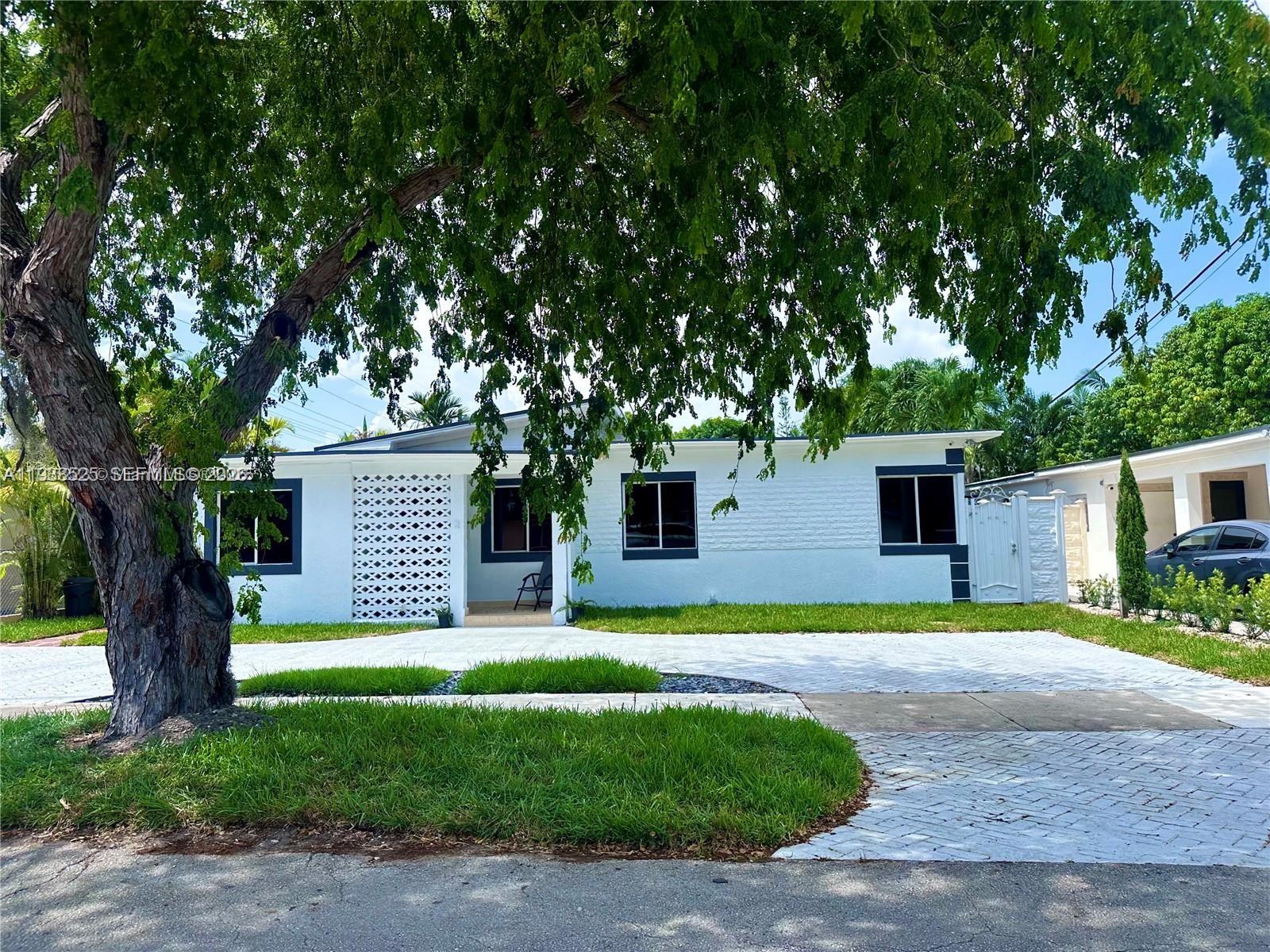 a house with a big yard and large trees