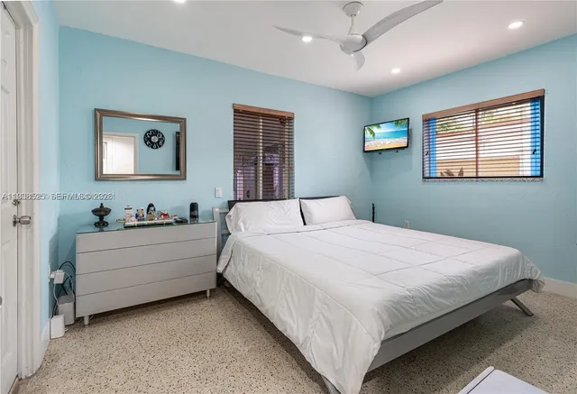 a bedroom with bed and a window