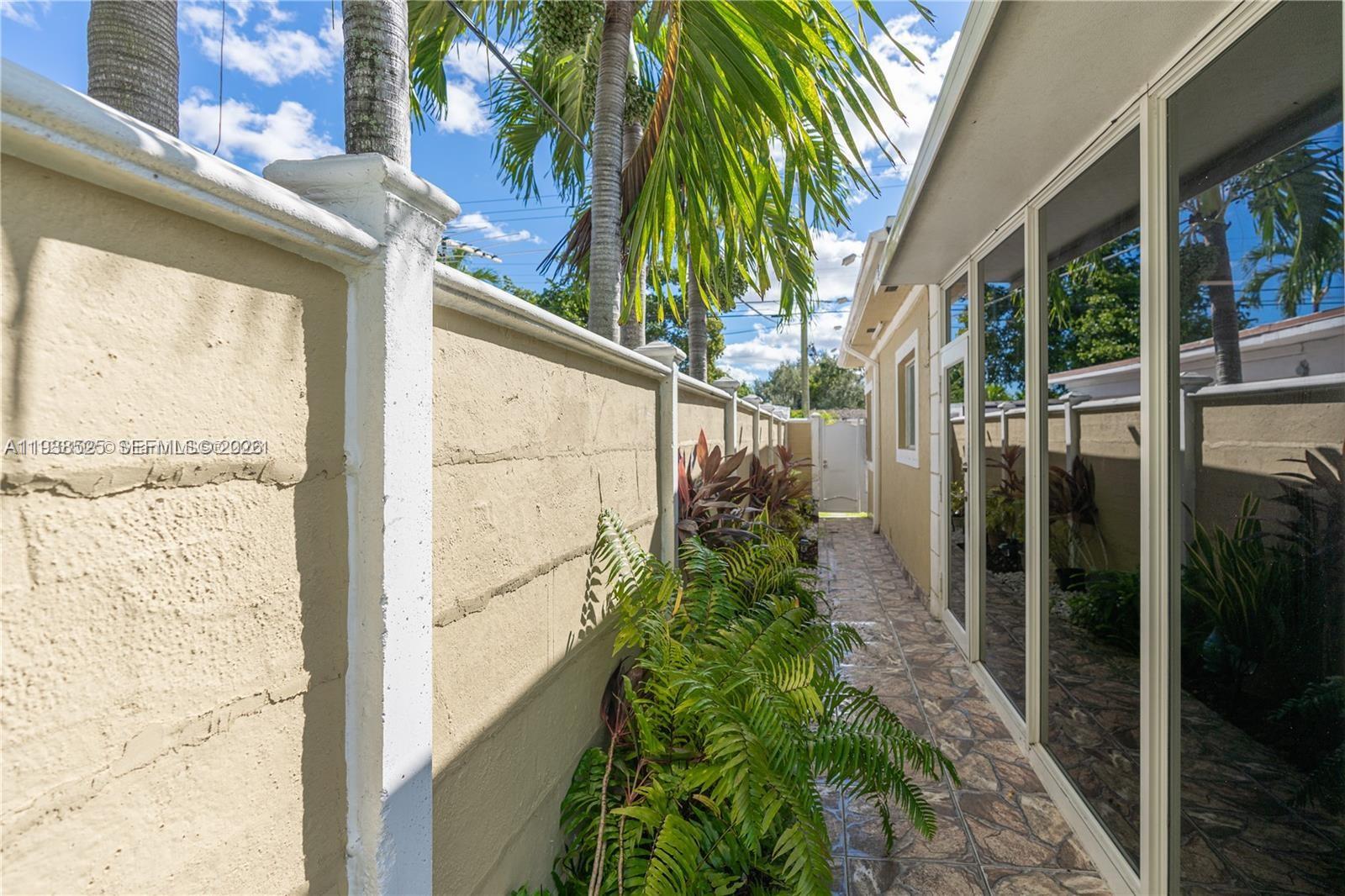 6181 Southwest 20th Street West Miami, FL 33155 - Photo 10 of 10 a view of a glass door with a tree in front