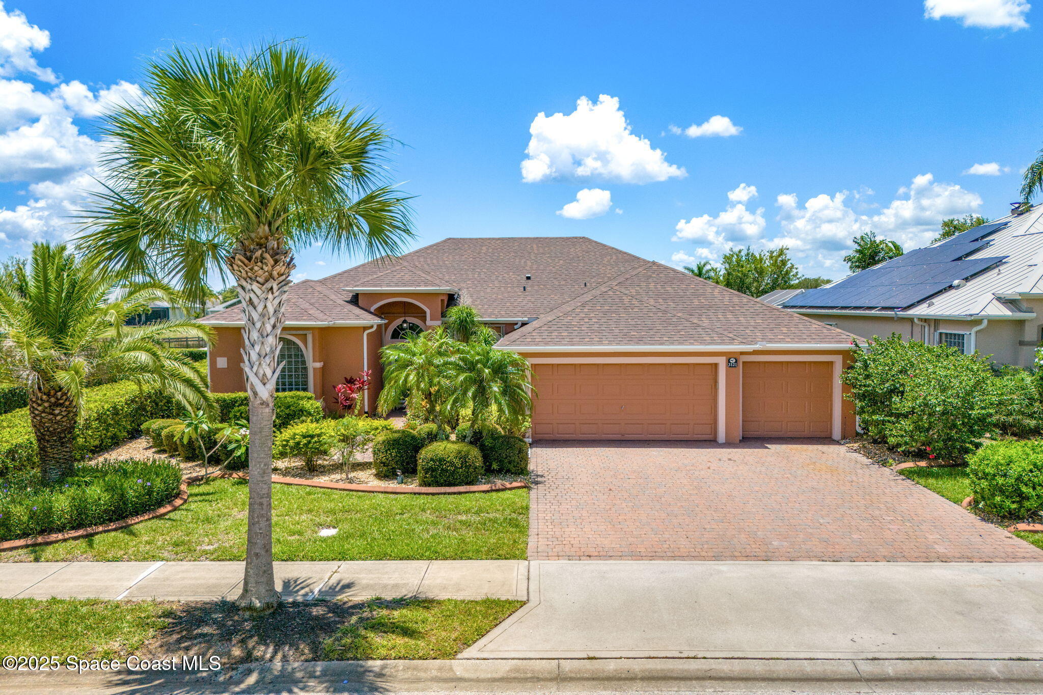 3121 Camberly Circle Melbourne, FL 32940 - Photo 1 of 52 a front view of a house with a yard and a garden