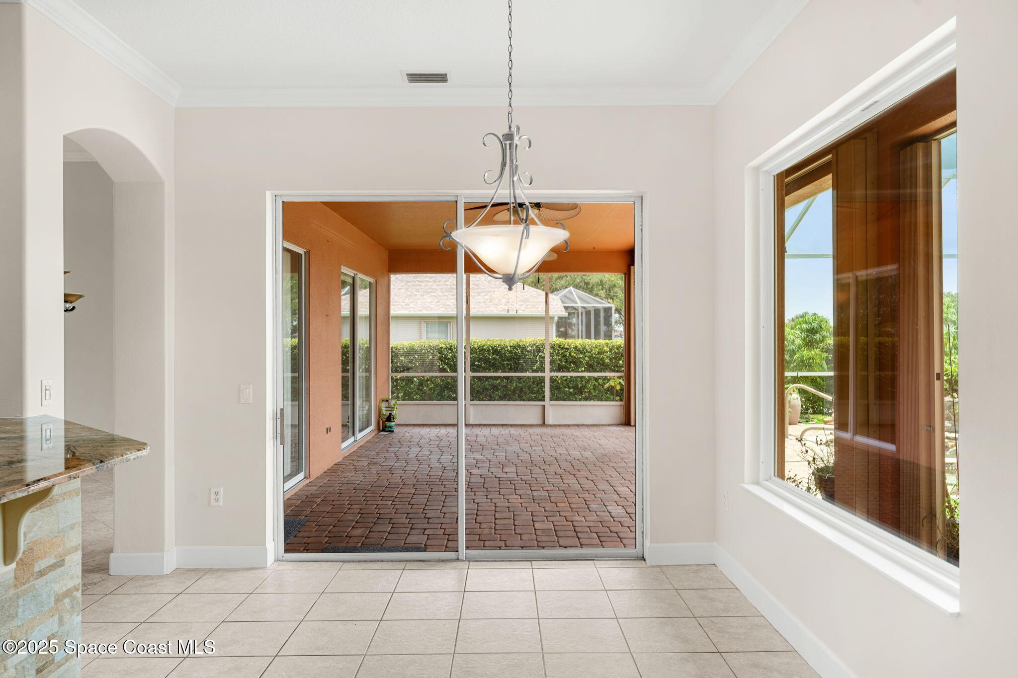 3121 Camberly Circle Melbourne, FL 32940 - Photo 12 of 52 a room with window and a chandelier