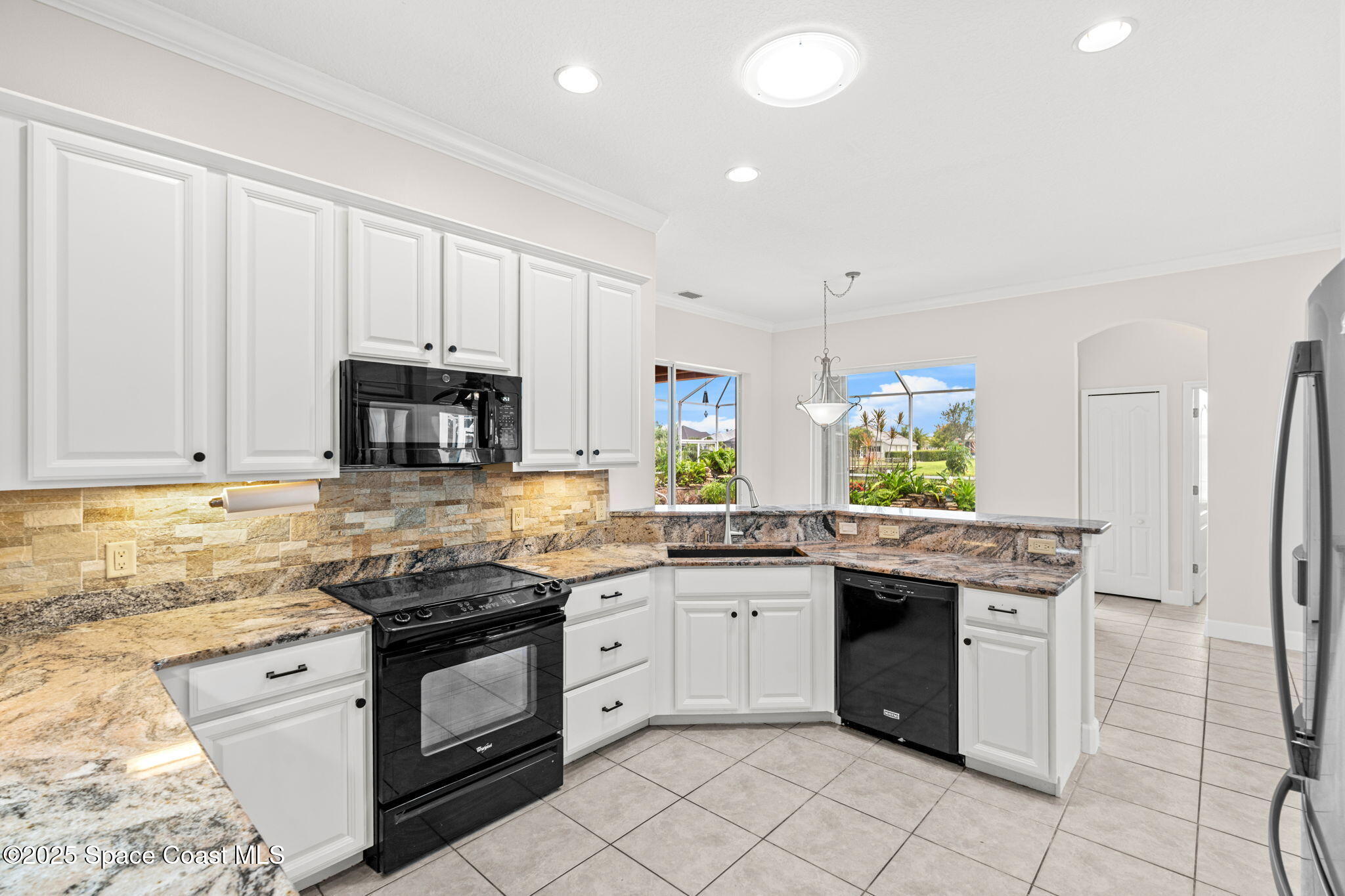 3121 Camberly Circle Melbourne, FL 32940 - Photo 15 of 52 a kitchen with stainless steel appliances granite countertop a stove a sink and a refrigerator
