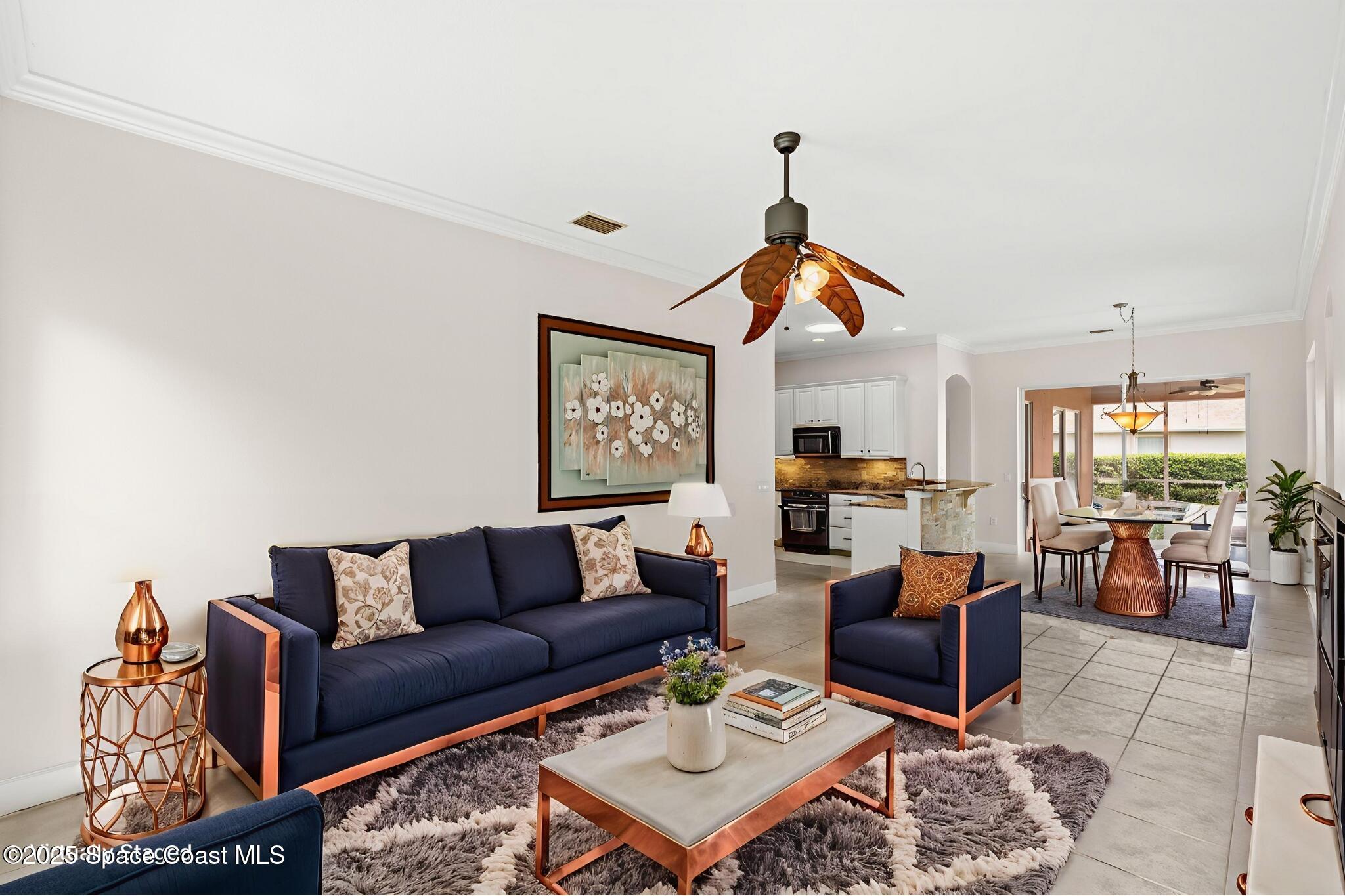 3121 Camberly Circle Melbourne, FL 32940 - Photo 17 of 52 a living room with furniture a rug and a window