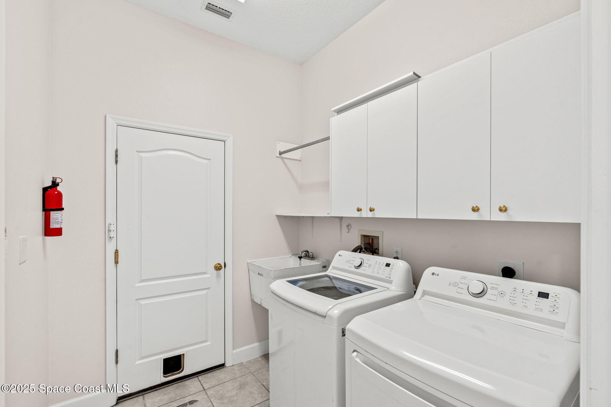 3121 Camberly Circle Melbourne, FL 32940 - Photo 28 of 52 a view of storage and utility room with washer and dryer