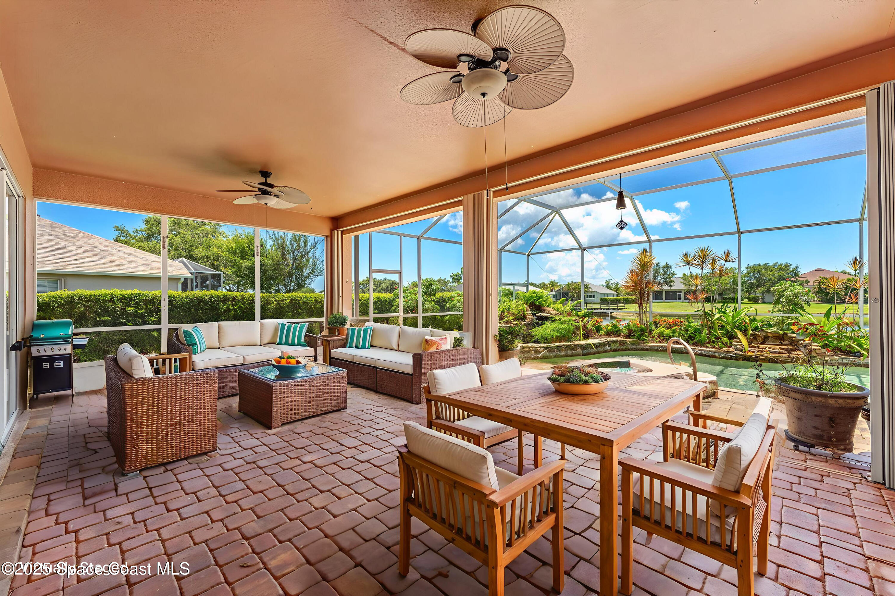 3121 Camberly Circle Melbourne, FL 32940 - Photo 3 of 52 a living room with patio furniture and a potted plants