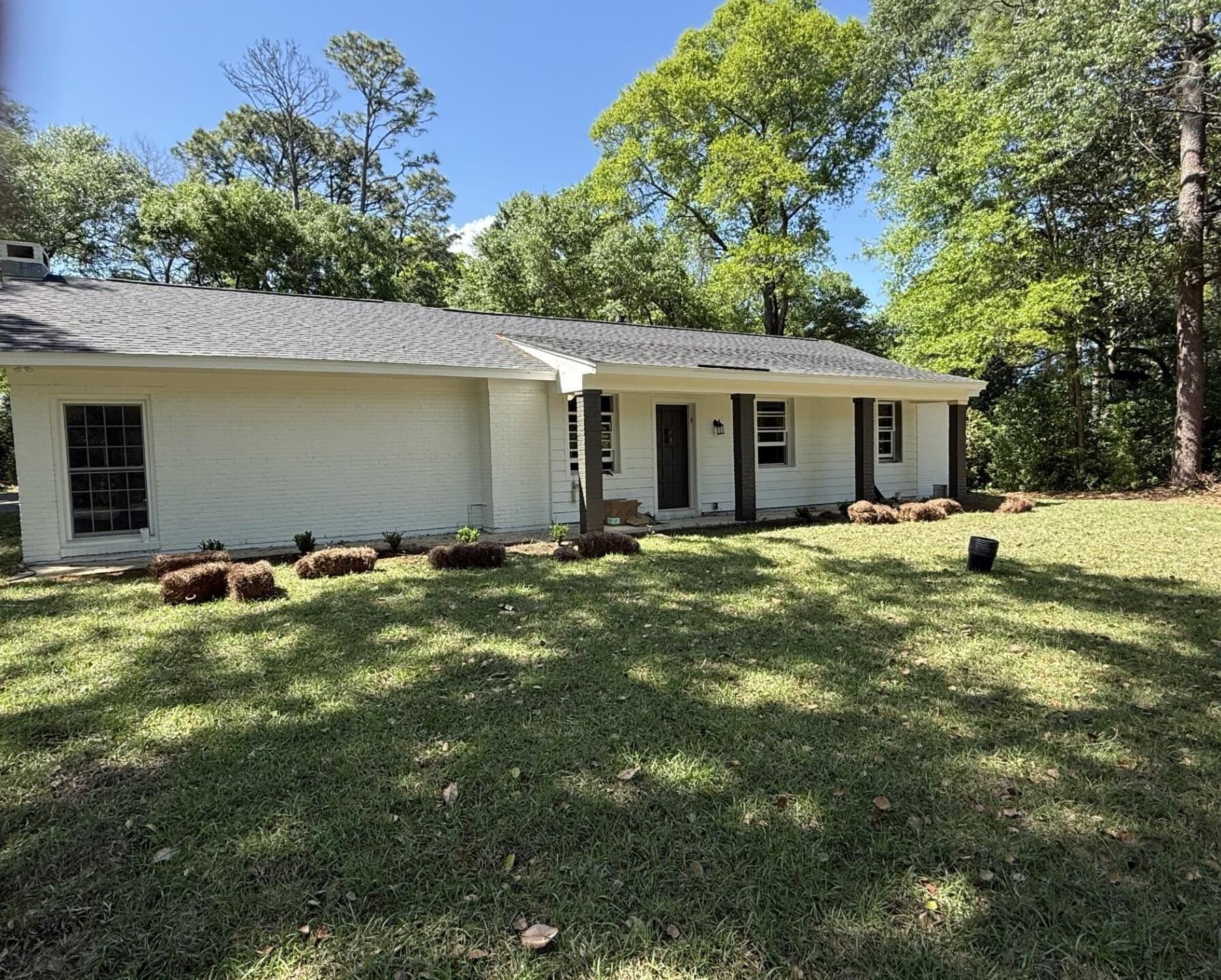 4700 Bit And Spur Road Mobile, AL 36608 - Photo 2 of 21 View of front of house with a porch, roof with shingles, a front yard, and brick siding