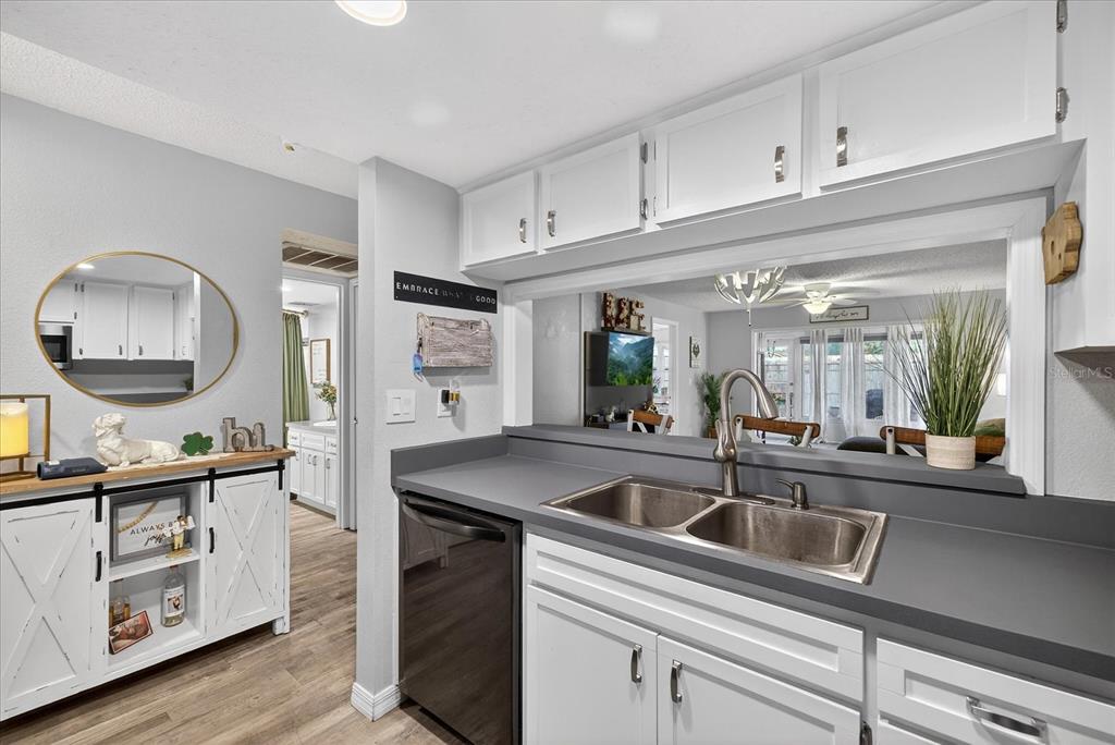 3230 Teeside Drive New Port Richey, FL 34655 - Photo 6 of 32 a kitchen with stainless steel appliances a sink a stove and a wooden floors
