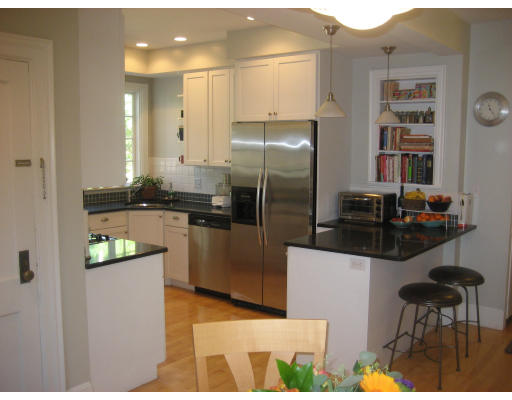 131 Gardner Road, Unit 1 Brookline, MA 02445 - Photo 9 of 10 a kitchen with stainless steel appliances kitchen island granite countertop a refrigerator and a stove