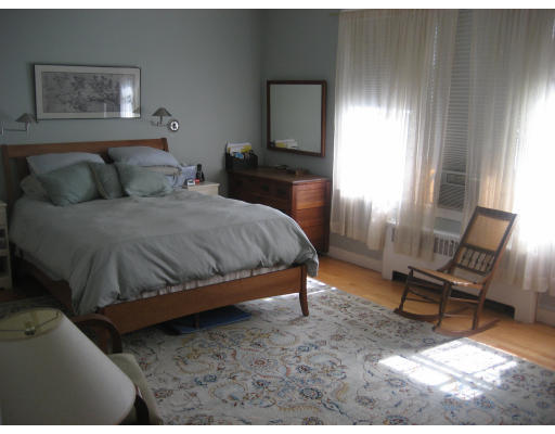 131 Gardner Road, Unit 1 Brookline, MA 02445 - Photo 10 of 10 a bedroom with a bed a table and chair