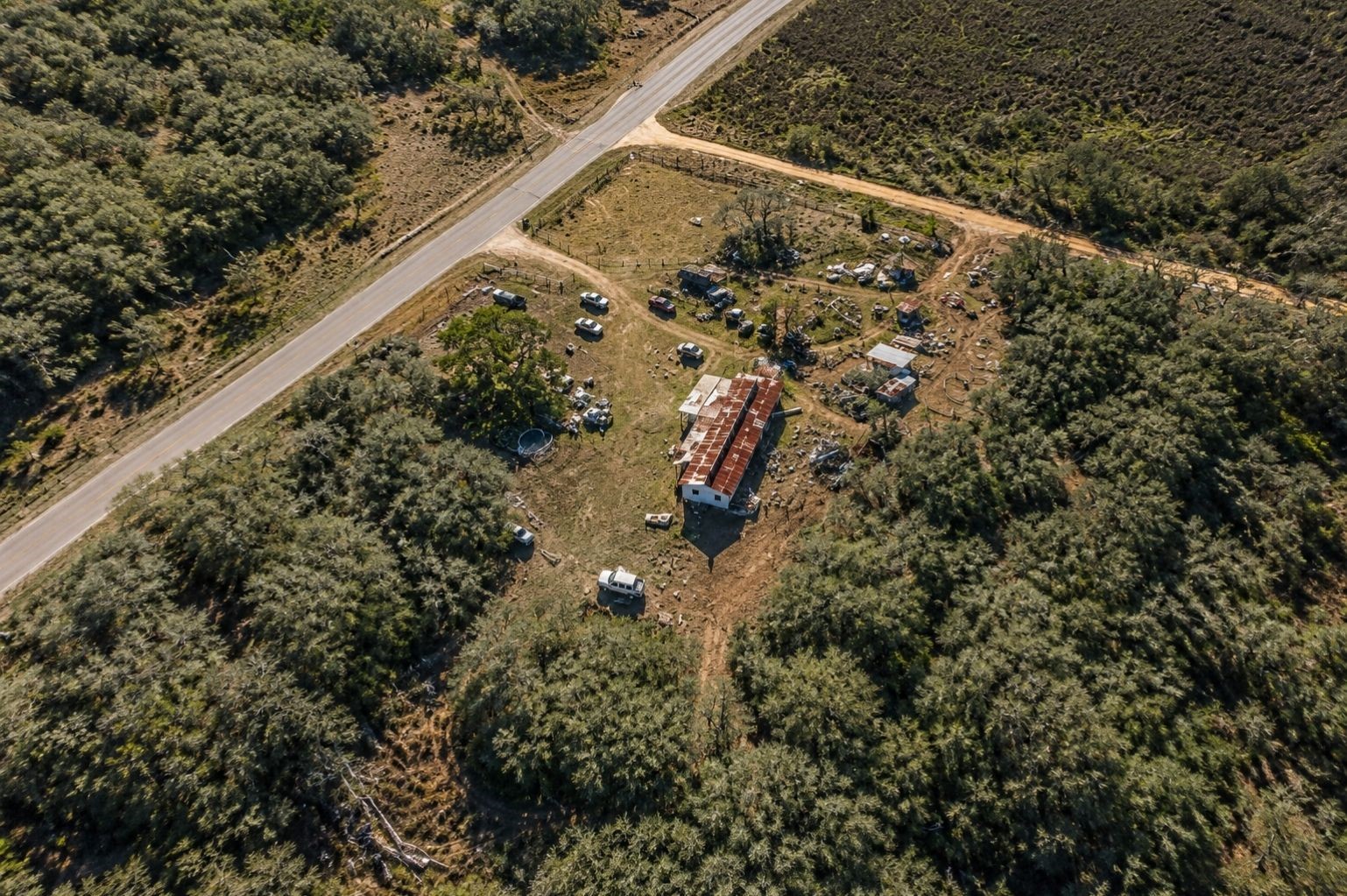 9880 Dix Road Kingsbury, TX 78638 - Photo 39 of 39 Aerial property view showing the surrounding wooded landscape and road access, enhanced from Google Earth imagery.