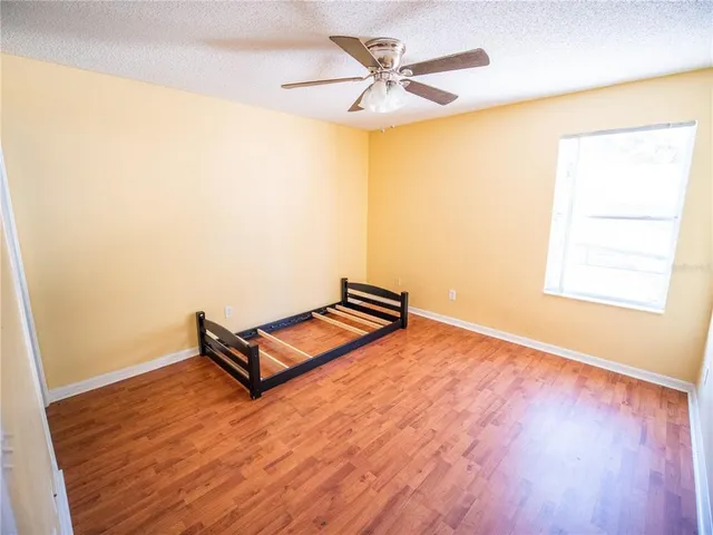 a living room with hard wood floors and a ceiling fan