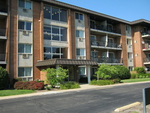 2234 South Goebbert Road, Unit 122 Arlington Heights, IL 60005 - Photo 1 of 29 a front view of a building with a garden