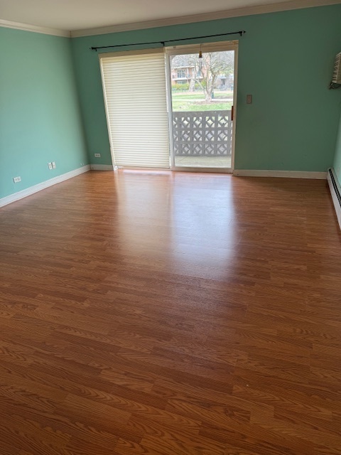 2234 South Goebbert Road, Unit 122 Arlington Heights, IL 60005 - Photo 11 of 29 an empty room with wooden floor and windows
