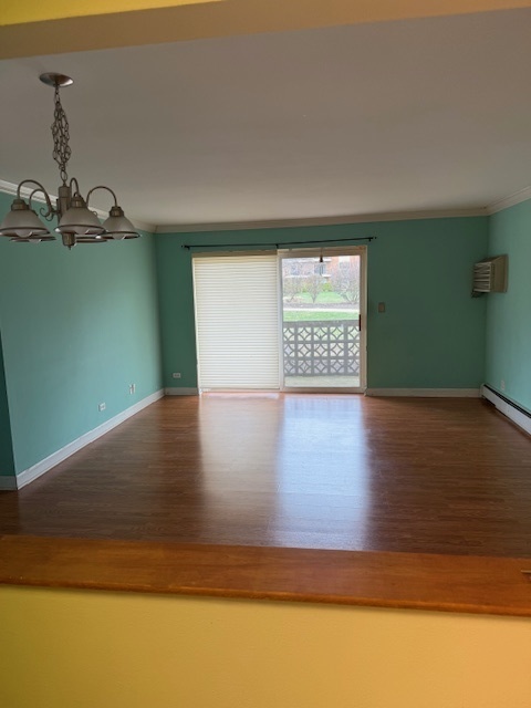 2234 South Goebbert Road, Unit 122 Arlington Heights, IL 60005 - Photo 12 of 29 a view of a room with window a ceiling fan and wooden floor