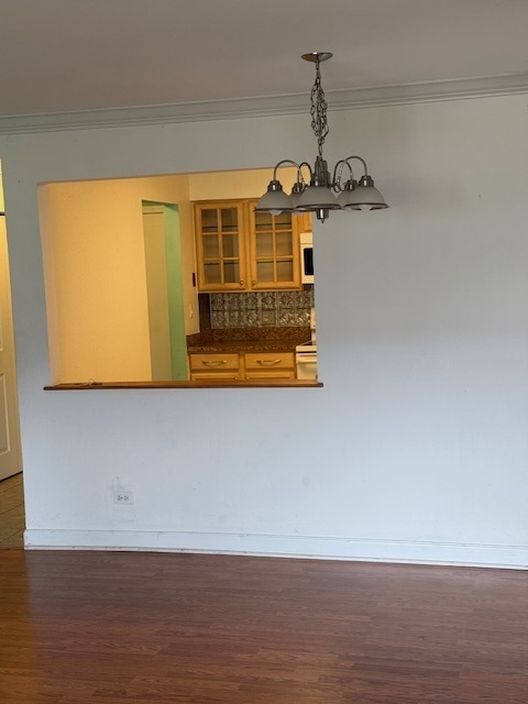 2234 South Goebbert Road, Unit 122 Arlington Heights, IL 60005 - Photo 15 of 29 a view of a room with wooden floor and cabinet