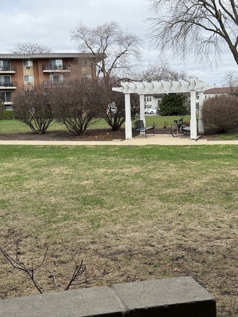 2234 South Goebbert Road, Unit 122 Arlington Heights, IL 60005 - Photo 28 of 29 a front view of a house with garden