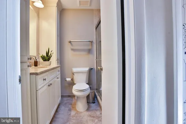 a bathroom with a toilet a sink and a mirror