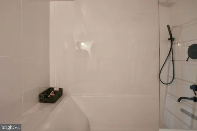 a bathroom with a shower and a bath tub