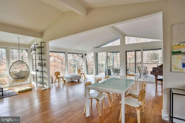 a view of a livingroom with furniture water view and large windows