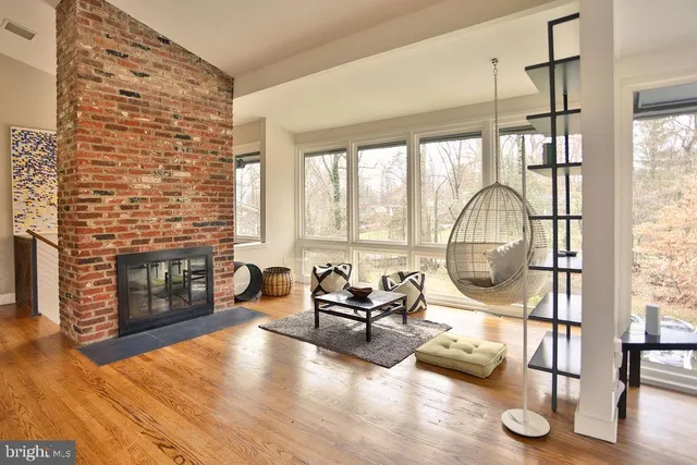 a view of a livingroom with furniture wooden floor and a fireplace