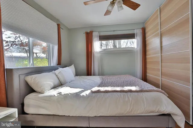 a bed sitting in a bedroom next to a window