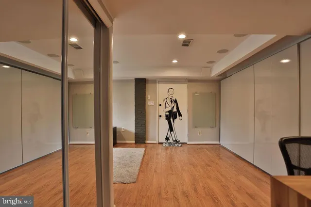 a view of a room with wooden floor