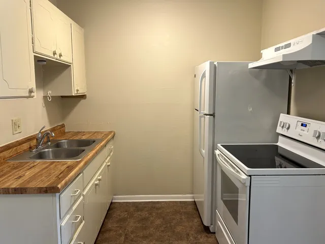 a kitchen with a refrigerator sink and stove