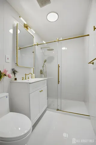 a bathroom with a sink a toilet and shower