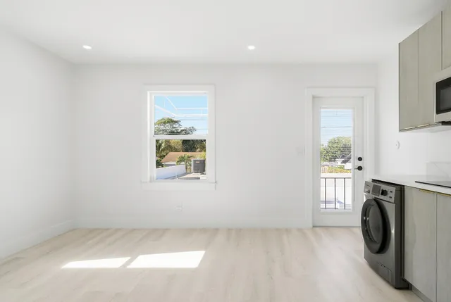 an empty room with a fireplace and a window