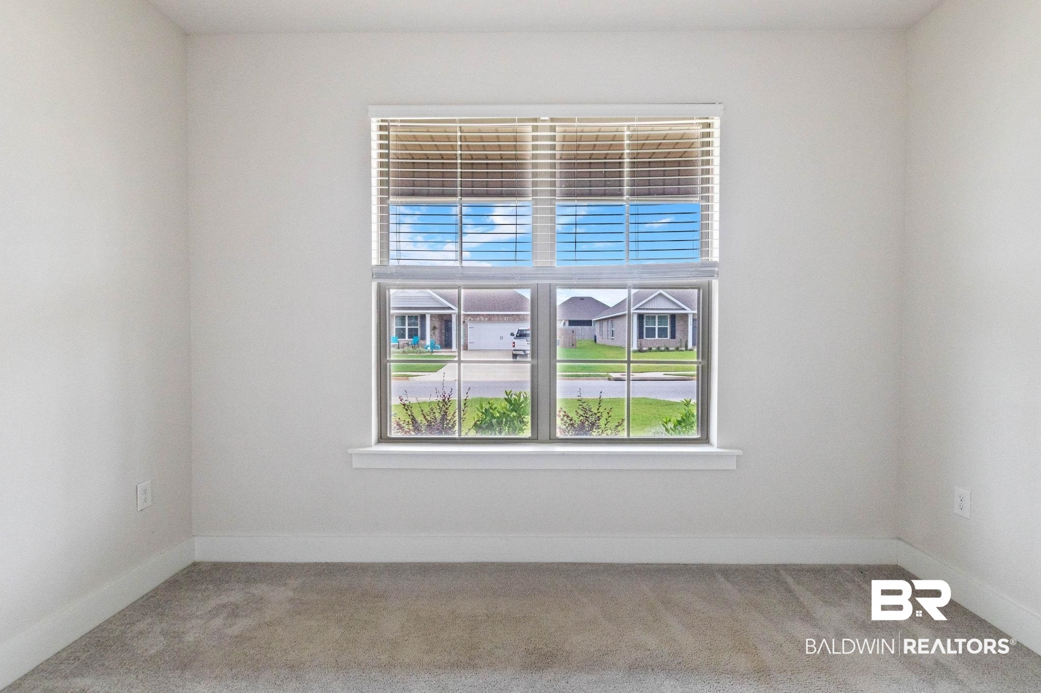 1710 Grouse Street Foley, AL 36535 - Photo 54 of 76 Window with horizontal blinds, neutral wall paint, white trim, and grey carpet flooring