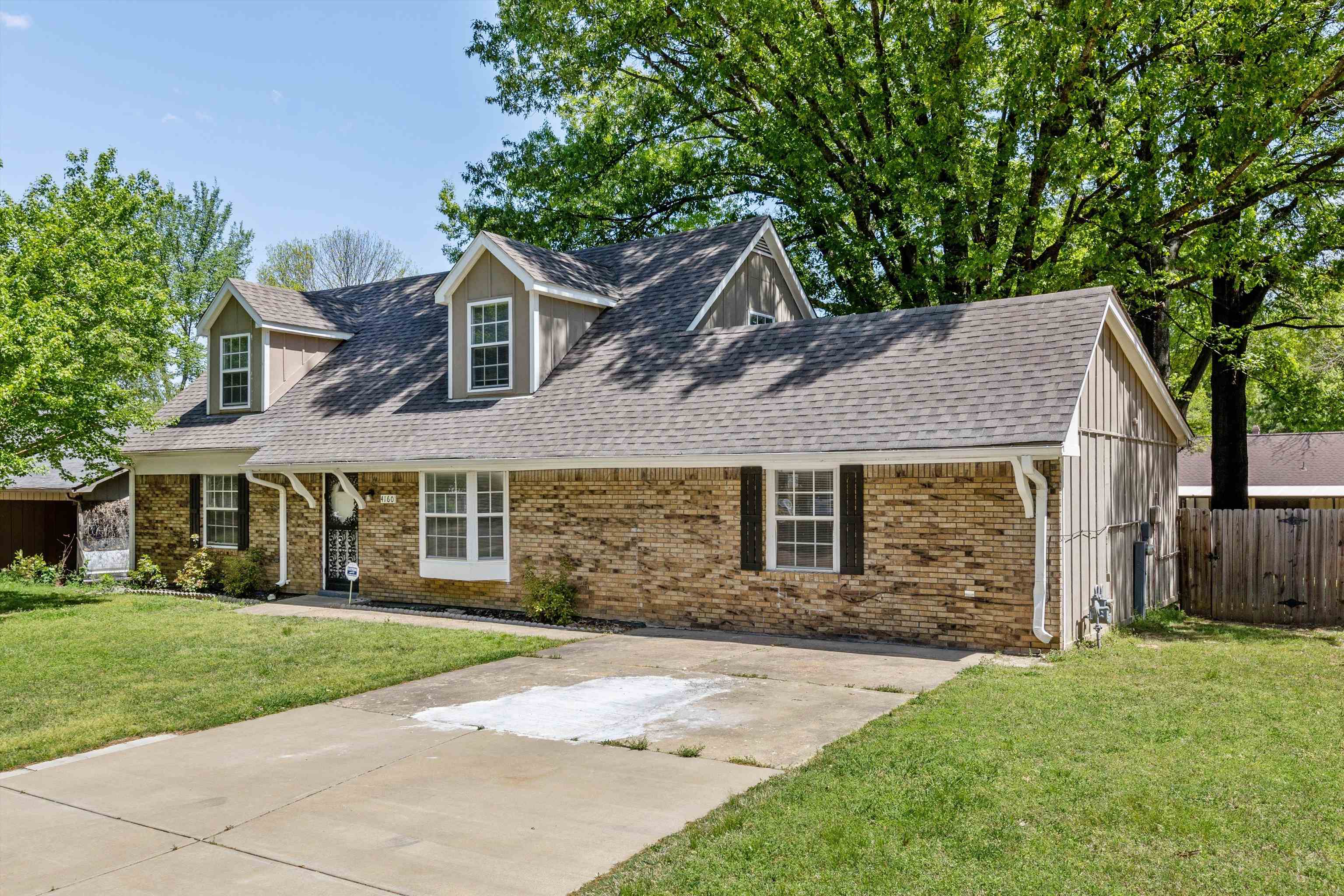4160 Luther Road Bartlett, TN 38135 - Photo 2 of 28 Cape cod-style house featuring a front lawn, driveway, a shingled roof, fence, and brick siding