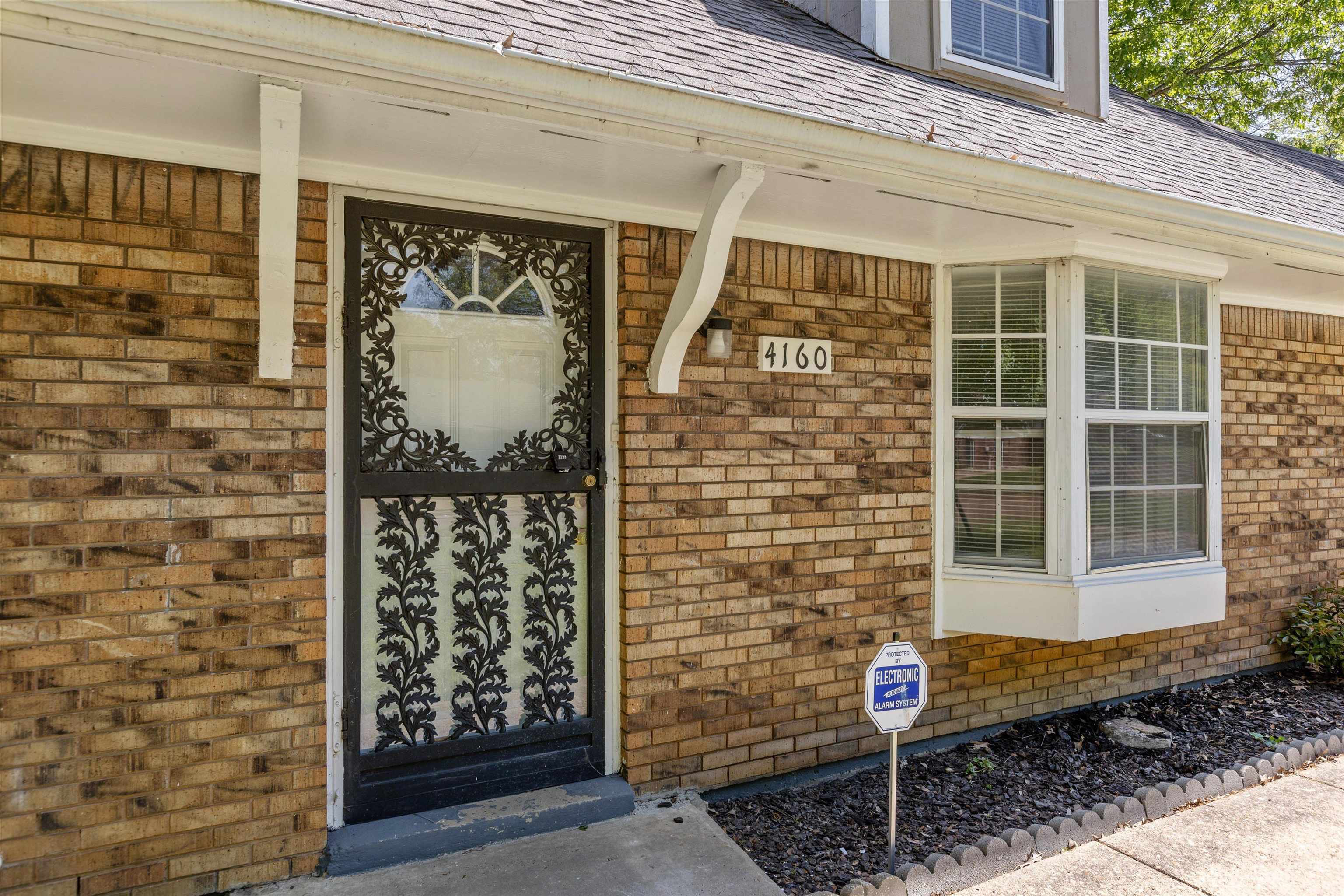4160 Luther Road Bartlett, TN 38135 - Photo 3 of 28 Doorway to property with covered porch, brick siding, and roof with shingles