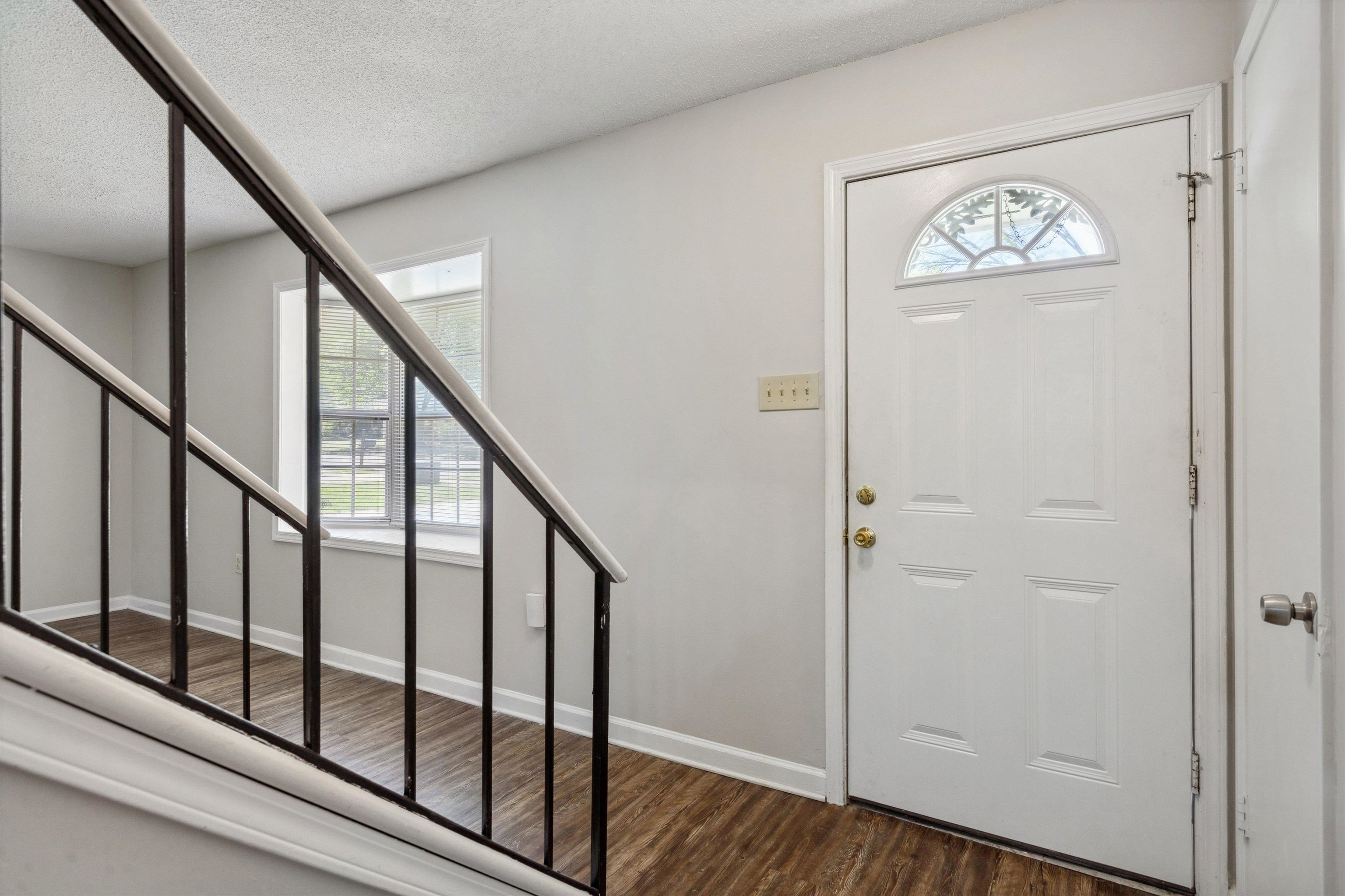 4160 Luther Road Bartlett, TN 38135 - Photo 4 of 28 Entrance foyer with baseboards, wood finished floors, a textured ceiling, and stairs