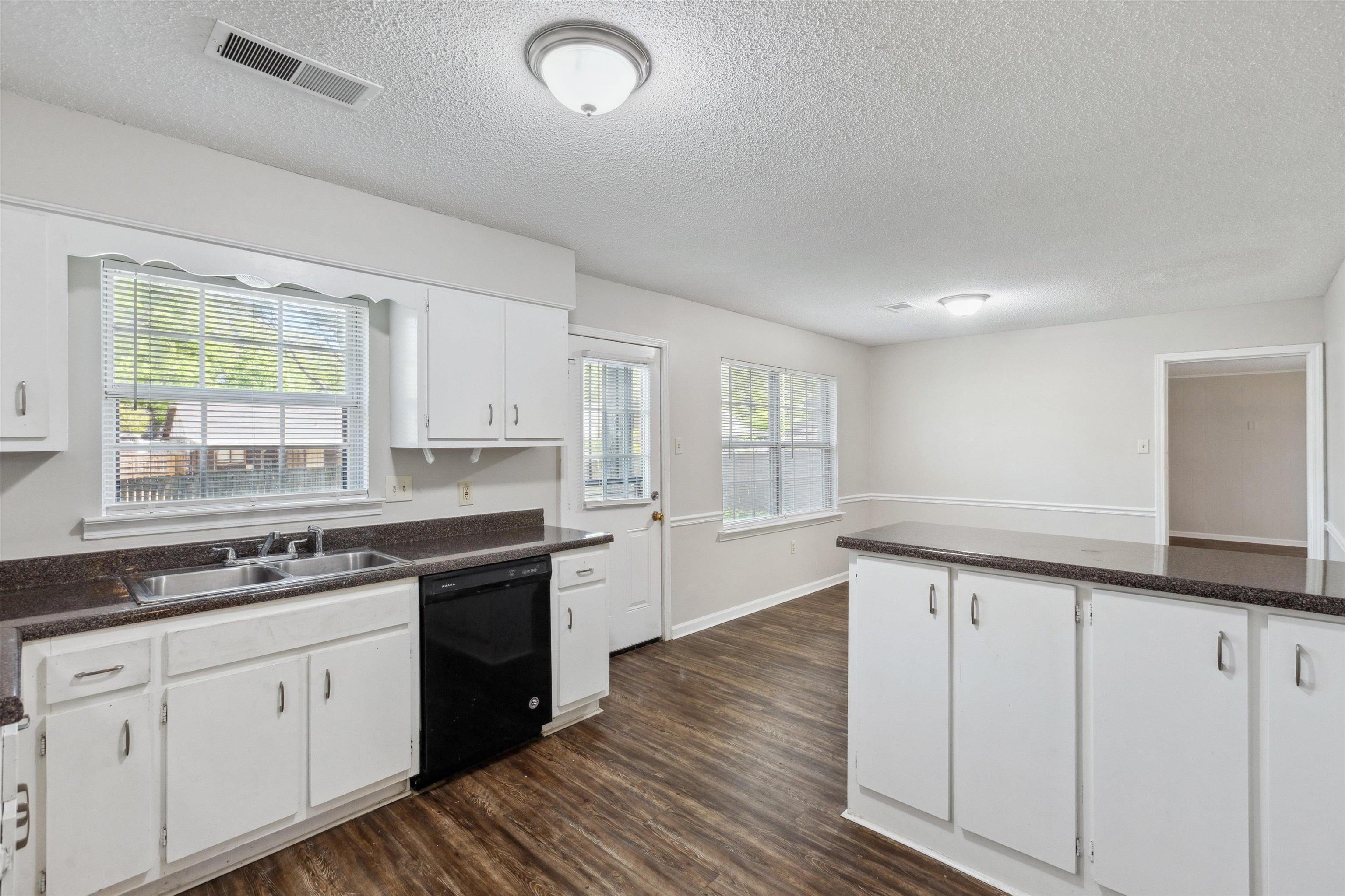 4160 Luther Road Bartlett, TN 38135 - Photo 10 of 28 Kitchen with dark countertops, black dishwasher, visible vents, and a sink