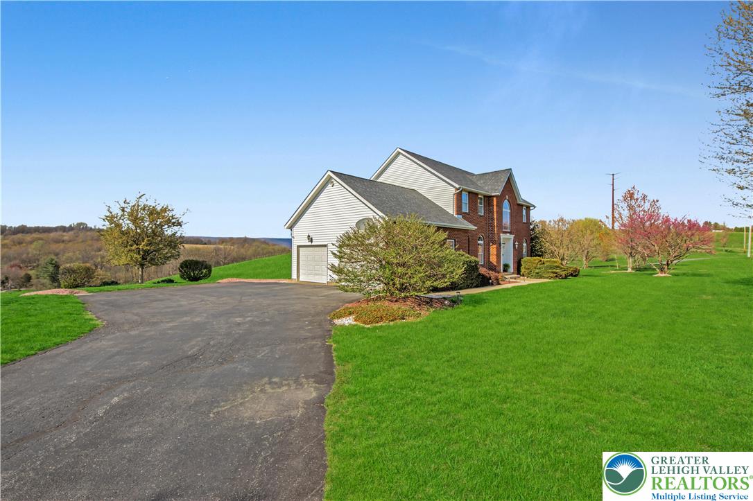 3110 Valley View Drive Bath, PA 18014 - Photo 57 of 64 a view of a house with a big yard potted plants and a back yard